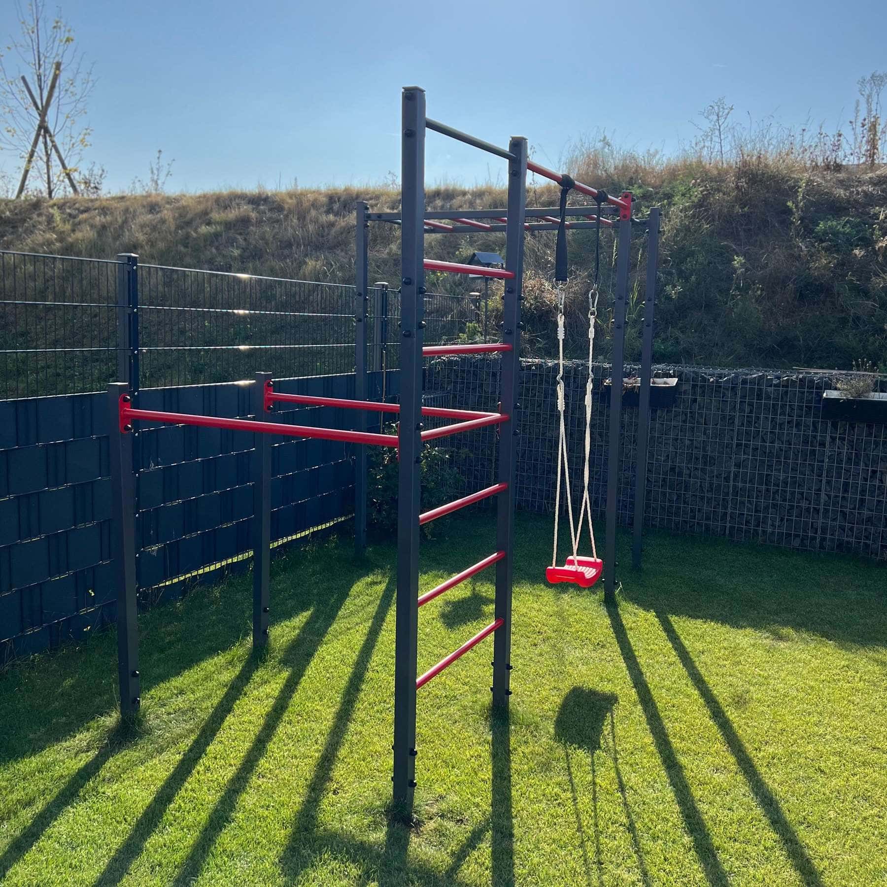 K-Sport Outdoor Calisthenics Station with Monkey Bars and Swing, installed in a garden